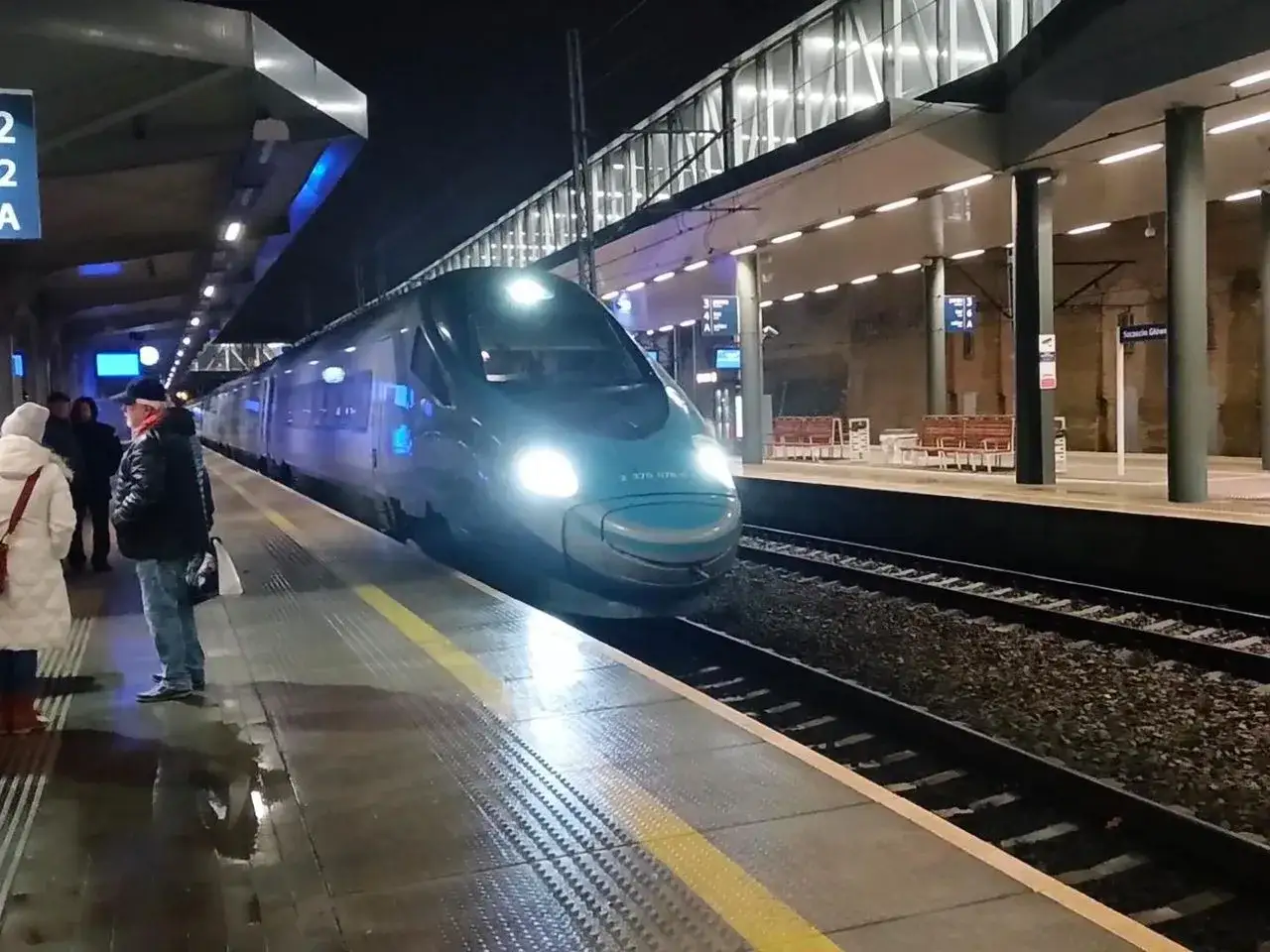 Pendolino Warszawa Szczecin na nocnym peronie. Pasażerowie czekają na podróż.